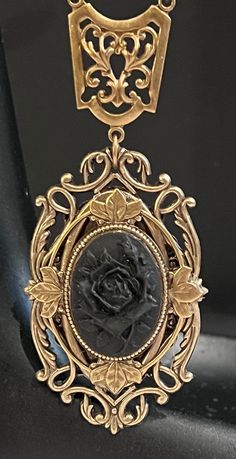 "The 25x18mm black on black rose resin cameo is set in a lovely antique bronze ornate Victorian floral setting. The 20\" antique bronze cable chain necklace with a lobster claw closure and 2.5\" extender chain is embellished with  jet black glass faceted beads and rondeles and antique bronze filigree findings.  Pendant length: 3.0\" Pendant width: 1.5\" Necklace length: 20\" w/2.5\" extender Other necklace lengths are available in the pull down menu or request a custom necklace length.  All Moon Grove Designs jewelry comes beautifully gift boxed and ready for giving to yourself or someone special." Antique Black Nickel-free Necklace, Antique Black Brass Necklace, Elegant Black Jewelry With Antique Finish, Vintage Black Cameo Jewelry, Gothic Bronze Jewelry With Antique Finish, Gothic Black Brass Necklace, Black Gothic Brass Necklace, Black Cameo Jewelry For Collectors, Black Cameo Medallion Jewelry