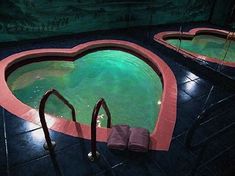 an empty swimming pool with steps leading up to the bottom and green water in it