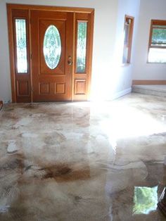 a room with a door and two windows on the floor that has been stained white