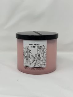 a candle that is sitting on a white surface with the words weekend in rome printed on it