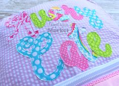 a close up of a pink and blue bag with the word love spelled in large letters