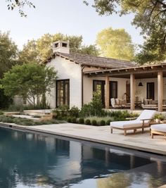 a house with a pool in front of it and some chairs around the pool area