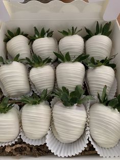 a box filled with white chocolate covered strawberries