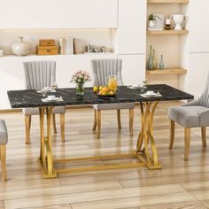 a dining room table with chairs and a vase filled with flowers on top of it