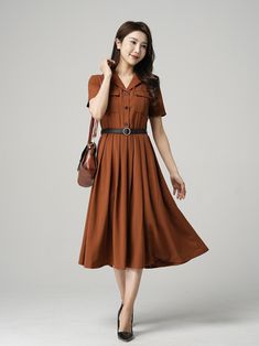 "This stunning brown shirt dress is a versatile piece that can be dressed up or down depending on the occasion. Featuring elegant pleats, this dress is perfect for both work and play. The short sleeves make it perfect for warmer weather, while the brown color gives it a classic look that will never go out of style. Pair it with heels for a sophisticated office look or sandals for a casual day out. DETAIL * The brown dress contain 50% polyester, others are nylon,fiber * Has no pockets * Right sid Brown Shirt Dress Outfit, Brown Buttoned Summer Dresses, Brown Summer Dresses With Buttons, A-line Dress With Placket For Work, V-neck Office Lady Dress With Buttons, V-neck Office Dress With Buttons, Office Lady Style Dress With Button Closure For Spring, Brown Workwear Dress With Pockets, Classic Midi-length Dresses With Pockets