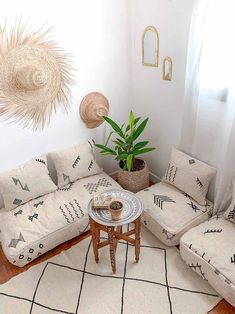 a living room filled with furniture and a potted plant