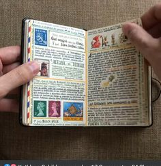 a person holding an open book with stamps on it