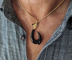 Hawaiian fish hook, carved black horn makau necklace on braided hemp. This is a fully adjustable necklace. A beachy combination that's so comfortable you'll wear it everyday. TO SEE MORE OF OUR SIMILAR UNISEX NECKLACE DESIGNS: https://www.etsy.com/shop/JTMauiDesigns?ref=l2-shopheader-name§ion_id=18502178 NECKLACE SIZING TIPS: This necklace is on an adjustable hemp string. if desired the ends of the hemp may be cut and tied after the recipient chooses the length they need to get it over their head. GIFT? Choose gift wrap for $1 at checkout if you'd like a linen bag included. We are happy to send direct to your recipient if you are gifting it. QUESTIONS: We are known for our quick response time, and creation time. If there are any questions you have on your order, please check back within yo Maui Style, Hawaiian Fish, Fish Hook Necklace, Hook Necklace, Surfer Style, Unisex Necklace, Linen Bag, Adjustable Necklace, Fish Hook