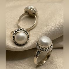 Introducing Our Stunning 925 Sterling Silver Pearl Rings Featuring Beautiful Granulation Accents And Intricate Twisted Wire Work. Perfect For Those Who Appreciate Fine Craftsmanship And Timeless Elegance. Product Details: Product: Ring Metal: 925 Sterling Silver Sizes Available: Us 6, 8, And 9 Pearl Size: 10mm Round Total Weight: 7.25 Grams These Rings Showcase A Gorgeous Pearl Set In High-Quality Silver, Enhanced By Delicate Granulation Detailing And Sophisticated Wire Work, Making Each Piece T White Sterling Silver Pearl Ring Gift, Classic Silver Pearl Ring In Sterling Silver, Classic Sterling Silver Pearl Ring With Gemstone, White Pearl Ring Stamped 925, White Pearl Ring Stamped 925 As Gift, Elegant Sterling Silver Pearl Ring Stamped 925, White Sterling Silver Pearl Ring, White Pearl Sterling Silver Ring, Classic White Sterling Silver Ring