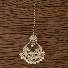 Whether you are the bride or sassy bridesmaid, no lehenga is complete without a maang tikka. This Kundan pearl maang tikka is perfect to steal the show with its elegance . The meticulous attention paid to the craftsmanship makes it an epitome of jewelry inspiration. Height = 190 mm || Width = 75 mm Bollywood Look Indo Western Maang Tikka Light in weight. 100% Satisfaction Guarantee: Long Lasting Plating, High-Quality Stones. Gifting: This pair of charming maang tikka come in a beautiful gift bag Wedding Kundan Tikka With Tilla Details, Temple Jewelry Tikka For Wedding And Eid, Kundan Tikka For Wedding, Temple Jewelry Style, Kundan Temple Jewelry Tikka For Wedding, Stone Work Tikka For Wedding And Diwali, Wedding Tikka With Stone Work For Diwali, Bollywood Style Wedding Tikka With Pearl Drop, Bollywood Style Wedding Tikka For Eid, Wedding Kundan Tikka With Mirror Work