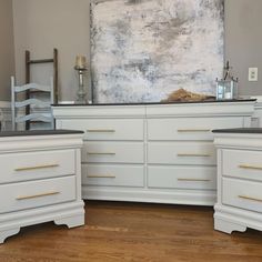 two white dressers sitting next to each other on top of a hard wood floor