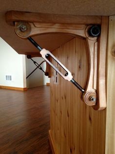 a close up of a wooden table with two handles on the top and one handle attached to it