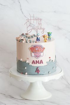 a birthday cake with paw patrol characters on it