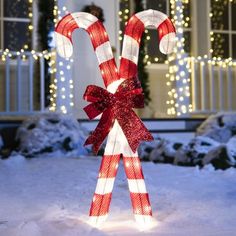 lighted candy canes in front of a house