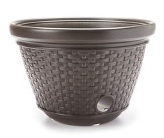 a brown basket style planter sitting on top of a white surface