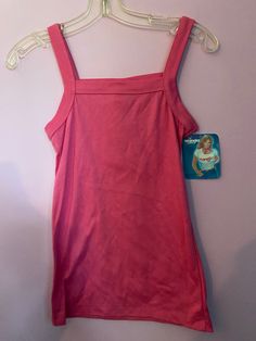 Vintage 1980's pink stretch knit (poly/cotton) tank top mage by Wrangler Juniors. Poly/cotton  Size Small, measurements are (unstretched, flat) 30" chest (up to 34-36) 24" top of shoulder to bottom hem. 90s Style Stretch Tank Top For Spring, 90s Style Stretch Cotton Tank Top, 90s Fitted Camisole Tops, 90s Style Fitted Camisole Tops, Pink Fitted Tank Vest, Pink Fitted 90s Style Tank Top, Fitted Sleeveless 90s Tops, Pink Sleeveless Cotton Camisole, Pink Stretch Cotton Tank Top