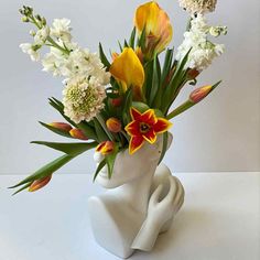 a vase with flowers in it sitting on a table