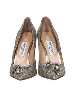 Celebrate the holidays in style with these stunning Jimmy Choo Dempsey pumps! A silver and champagne color palette and pointed toe will make you the belle of the ball, while the charm buttons add a special glitz, perfect for ringing in the new year! Size 10 (IT 40) Made in Italy Leather lining Metallic shell Toe charms Comes with dust bag Heel height 4" Elegant Embellished Heels For Holidays, Elegant Embellished Heels For The Holidays, Holiday Formal Heels With Pointed Toe, Chic Embellished Champagne Heels, Elegant Holiday Heels For Events, Chic Heels For Wedding And Holiday, Chic Champagne Wedding Shoes, Chic Champagne Wedding Shoes For Evening, Elegant Holiday Event Heels