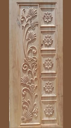 an intricate carved wooden door with flowers and leaves