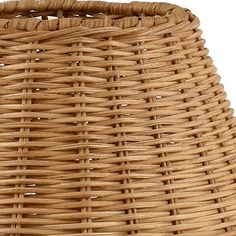 a large round wicker basket on a white background