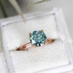 an engagement ring with a blue diamond in it