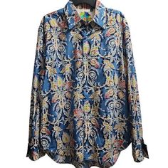 Make A Bold Statement With This Eye-Catching Shirt. Featuring An Intricate Paisley Print On A Vivid Blue Background, This Long-Sleeve Button-Down Is Perfect For The Fashion-Forward Man. Ideal For Casual Outings, Date Nights, Or Adding Flair To Your Office Attire. The Colorful Design And Quality Craftsmanship Embody Luxury And Individuality, Making It A Versatile Piece For Any Stylish Wardrobe. 48 Inch Chest Sleeve Length: Long Sleeve Color: Blue Department: Men Type: Button-Up Pattern: Paisley C Blue Paisley Print Long Sleeve Shirt, Classic Blue Paisley Print Tops, Fall Cotton Shirt With Paisley Print, Designer Blue Tops With Buttons, Designer Blue Button-up Top, Blue Cotton Tops With Paisley Print, Blue Paisley Print Button-up Top, Designer Printed Blue Tops, Designer Blue Printed Tops