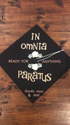 a graduation cap that says in omnia ready for anything paratus thanks mom and dad