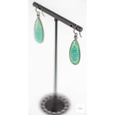 Indulge in the beauty of the ocean with these stunning, shimmering seafoam green and aqua blue Amazonite drop earrings. The bright bright Amazonite perfectly complements the gray niobium ear wires, creating a mesmerizing contrast of colors. Be charmed by the alluring beauty of these limited edition sea green amazonite drop earrings. Each gemstone features a unique striated pattern in shades of aqua blue, sea green, lemon yellow, and white, reminiscent of the ocean's natural beauty. Measuring 1 i Amazonite Drop Earrings As Gift, Turquoise Amazonite Dangle Earrings, Turquoise Dangle Earrings With Amazonite, Green Jade Earrings For Healing, Handmade Turquoise Amazonite Earrings, Amazonite Natural Stone Earrings For Gifts, Dangle Earrings With Amazonite And Natural Stones, Turquoise Jade Earrings For Gift, Turquoise Amazonite Earrings For Gift