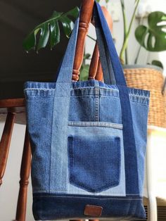 a blue tote bag sitting on top of a wooden chair