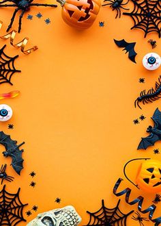 halloween decorations arranged on an orange background