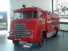 an old red fire truck on display in a museum