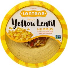 yellow lenti hummus with sunflower seeds in a bowl on a white background