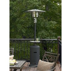 an outdoor patio heater sitting on top of a wooden deck