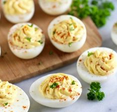 deviled eggs on a cutting board with parsley