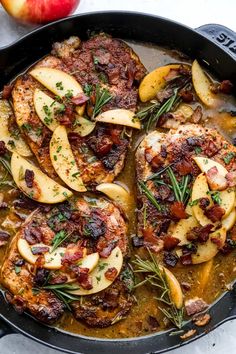 pork chops with apples and herbs in a skillet