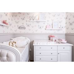 a baby's room is decorated in pink and white