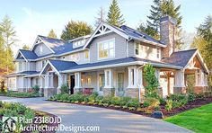 a large house with lots of windows in the front yard and landscaping on the side