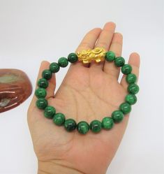 Vintage 24K 999 Pure Gold 3D Pixiu with Green Jadeite Jade Bead Elastic Bracelet ....Marked 999 ...Total of weights 34.1grams...With 21 Green Jadeite Jade Beads 10MM ...Measure of Pixiu H 13.1MM W 28MM...It's in very good condition. #441259 Malachite 8mm Beads Jewelry Gift, Gold Malachite Bracelet, Green Jade Bracelets With Round Beads, Hand-strung Malachite Bracelets As Gift, Green Jade 8mm Beads Jewelry, Gold Malachite Jewelry Hand-strung, Hand-strung Jade Bracelets In Gold, Hand-strung Malachite Bracelets For Gifts, Hand-strung Gold Jade Bracelets