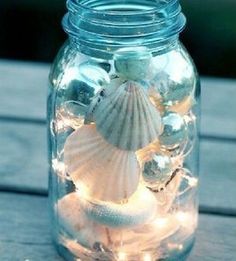 a mason jar filled with seashells and starfish