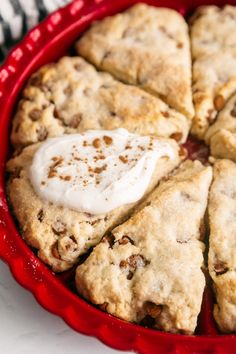 a pie with cream on top in a red dish