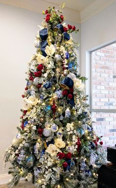 a decorated christmas tree with red, white and blue ornaments