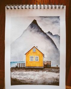 a drawing of a yellow house with mountains in the background and watercolor pencils on paper