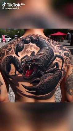 the back of a man's tattoo with an image of a scorpion on it