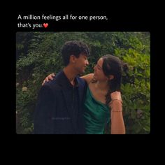 a man and woman standing next to each other in front of some bushes with the caption, a million feelings all for one person, that's you