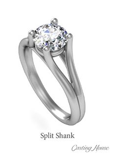 a white gold ring with a round cut diamond in the center and two clawed shanks on each side