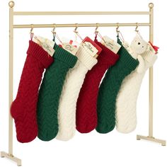 three stockings hanging from a rack on a white background