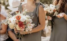 the bridesmaids are holding their bouquets together