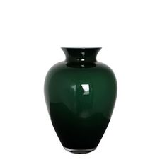 a large green vase sitting on top of a white table