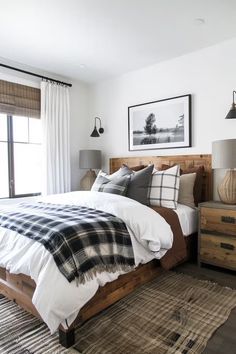 a bedroom with white walls and wooden furniture