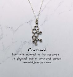 Cortisol Molecule Necklace. Cortisol is a steroid hormone that regulates a wide range of processes throughout the body, including metabolism and the immune response. Pendant size: 1 x 0.6 inch. Purchase includes a natural jewelry box and gift packaging. Gift? Add-on a hummingbird card for only $7: https://www.etsy.com/listing/202506976/nikola-jewelry-hummingbird-card Add-on extender: https://www.etsy.com/listing/197483038/add-on-necklace-extender-chain-with Necklace longer than 20 inches: https: Molecule Jewelry, Chemistry Jewelry, Doctor Jewelry, Molecule Necklace, Science Jewelry, Medical Jewelry, Cute Couple Gifts, Geek Jewelry, Necklace Extender